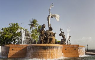 fountain with a statue of a greek god in the middle