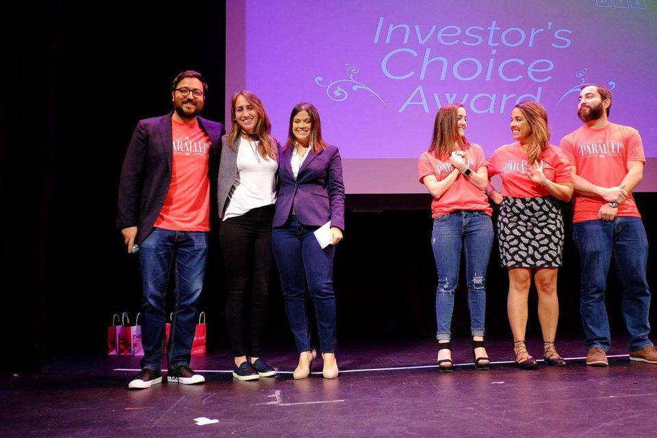 three members of the abartys health team posing on stage for the investor's choice awards